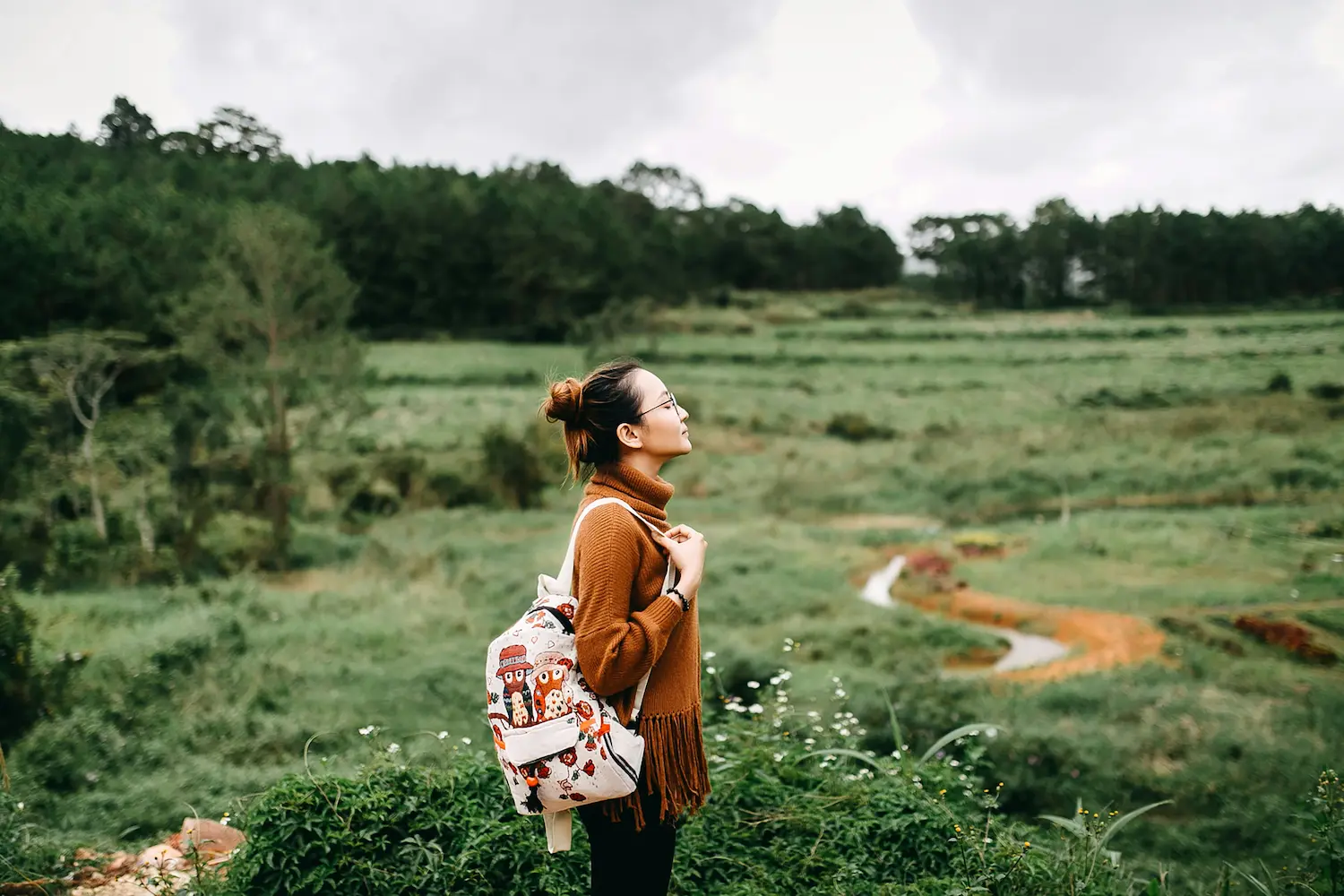 Woman standing in the middle of a grass field